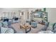 Comfortable loft area featuring a gray sofa, stylish decor, mounted TV, and desks for flexible workspace at 779 N Deer Park St, Watkins, CO 80137
