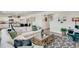 Open living area featuring an island kitchen, comfortable seating, and modern decor at 779 N Deer Park St, Watkins, CO 80137