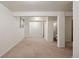Finished basement featuring neutral carpet, white walls, and an adjoining bathroom with shower at 5808 E Hinsdale Pl, Centennial, CO 80112