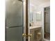 Bright bathroom featuring a glass shower door, vanity with storage, and neutral color palette at 5808 E Hinsdale Pl, Centennial, CO 80112