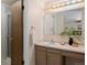 Bathroom featuring a large mirror, vanity with storage, neutral tones, and a well-lit space at 5808 E Hinsdale Pl, Centennial, CO 80112