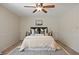 Cozy bedroom featuring a ceiling fan, neutral decor, and a comfortable bed with stylish pillows at 5808 E Hinsdale Pl, Centennial, CO 80112