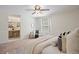 Sunlit bedroom with an ensuite vanity area, window, and soothing neutral color palette at 5808 E Hinsdale Pl, Centennial, CO 80112