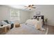 Bright bedroom with a large window, soft natural light, and a stylish chair creates a relaxing atmosphere at 5808 E Hinsdale Pl, Centennial, CO 80112