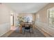 Spacious dining room with natural light, a stylish table set, and wainscoting detail at 5808 E Hinsdale Pl, Centennial, CO 80112