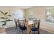 Bright dining room featuring a wooden table, black chairs, and an artistic painting at 5808 E Hinsdale Pl, Centennial, CO 80112