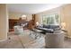 Inviting living room features a brick fireplace, plush seating, and large picture window at 5808 E Hinsdale Pl, Centennial, CO 80112