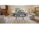 Bright living room featuring neutral decor, a cozy fireplace, and large window at 5808 E Hinsdale Pl, Centennial, CO 80112