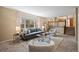 Comfortable living room with neutral tones, large window, and easy access to the kitchen at 5808 E Hinsdale Pl, Centennial, CO 80112