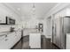 Modern kitchen with white cabinets, granite island, and stainless steel appliances at 9647 Colinade Dr, Lone Tree, CO 80124