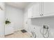 Laundry room with white cabinets, utility sink, and built-in storage at 9647 Colinade Dr, Lone Tree, CO 80124