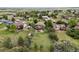 Aerial view of a green home with a large backyard, deck, shed, and mature trees in a neighborhood at 603 E 2Nd Ave, Castle Rock, CO 80108