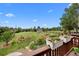 Large backyard with a shed, garden beds, mature trees, and a view from the wooden deck at 603 E 2Nd Ave, Castle Rock, CO 80108