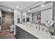 Bathroom featuring dual sinks with marble countertop and a shower with tile surround at 603 E 2Nd Ave, Castle Rock, CO 80108