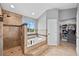 Large primary bathroom with walk-in shower, separate tub, and walk-in closet at 603 E 2Nd Ave, Castle Rock, CO 80108