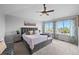 Spacious bedroom features large windows, gray carpeting, and a tray ceiling with ceiling fan at 603 E 2Nd Ave, Castle Rock, CO 80108