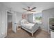 Cozy bedroom with window bench, ceiling fan, and doorway leading to bathroom at 603 E 2Nd Ave, Castle Rock, CO 80108