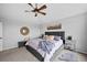 Comfortable bedroom featuring a gray upholstered bedframe, tray ceiling with ceiling fan, and neutral walls at 603 E 2Nd Ave, Castle Rock, CO 80108
