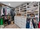 Walk-in closet with custom shelving and drawers to maximize storage and organization at 603 E 2Nd Ave, Castle Rock, CO 80108