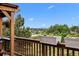 A covered wooden deck with a lovely view, framed by trees and planter boxes on the railing at 603 E 2Nd Ave, Castle Rock, CO 80108