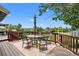 Spacious wooden deck with an outdoor dining set and views of the surrounding landscape at 603 E 2Nd Ave, Castle Rock, CO 80108