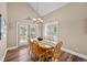 Cozy dining room features wood floors, vaulted ceiling, and french doors at 603 E 2Nd Ave, Castle Rock, CO 80108