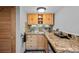 Compact kitchenette equipped with granite countertops and wooden cabinets at 603 E 2Nd Ave, Castle Rock, CO 80108