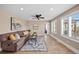 Open living room with tile floors, ceiling fan, and large windows for ample natural light at 603 E 2Nd Ave, Castle Rock, CO 80108