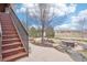 View of stone pathway and stairs in a landscaped backyard with neighborhood amenities at 11938 S Meander Way, Parker, CO 80138