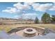 Backyard fire pit with stone surround and seating area with neighborhood view at 11938 S Meander Way, Parker, CO 80138