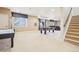 Finished basement features a pool table, neutral carpet, and access to a stairwell at 11938 S Meander Way, Parker, CO 80138