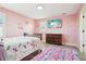 Pink-themed bedroom with a cozy bed, wooden dresser, and decorative unicorn wall stickers at 11938 S Meander Way, Parker, CO 80138