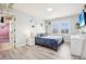 Cozy bedroom with a comfortable bed, side table, and a bright window with shutter-style blinds at 11938 S Meander Way, Parker, CO 80138