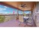 Covered wood deck with an outdoor table and chairs plus a grill at 11938 S Meander Way, Parker, CO 80138
