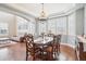 Elegant dining room with a decorative chandelier, large windows, and plenty of seating at 11938 S Meander Way, Parker, CO 80138