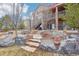 View of home's exterior with stone steps, landscaping, stairs and balconies at 11938 S Meander Way, Parker, CO 80138