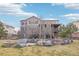 Home exterior showing backyard amenities, including a fire pit and seating area at 11938 S Meander Way, Parker, CO 80138