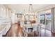 Spacious kitchen and dining area that features white cabinetry and an outdoor patio at 11938 S Meander Way, Parker, CO 80138