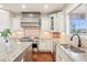 Bright kitchen featuring ample cabinetry, counter space and modern appliances, perfect for cooking at 11938 S Meander Way, Parker, CO 80138