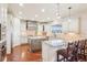 Kitchen boasts a large center island with seating, stainless appliances, and a gas cooktop at 11938 S Meander Way, Parker, CO 80138