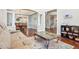 Open-concept living space featuring hardwood floors, decorative pillars, and views of the dining area at 11938 S Meander Way, Parker, CO 80138