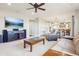 Spacious living room with a large TV, fireplace, and open floor plan into dining and kitchen areas at 11938 S Meander Way, Parker, CO 80138