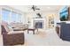 Comfortable living room features a cozy fireplace, built-in shelves, and plush seating at 11938 S Meander Way, Parker, CO 80138