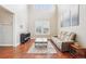 Spacious living room with high ceilings, hardwood flooring, bright light and comfortable seating at 11938 S Meander Way, Parker, CO 80138