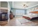 Serene main bedroom with fireplace, tray ceiling, ceiling fan, and ample natural light at 11938 S Meander Way, Parker, CO 80138
