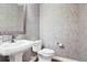 Stylish powder room with textured wallpaper, elegant mirror, and modern fixtures at 11938 S Meander Way, Parker, CO 80138