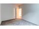 Simple bedroom with neutral carpet, door, and natural light from the window at 2847 Mount Royal Dr, Castle Rock, CO 80104