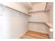 Walk-in closet features wood-look flooring, white walls, and metal shelving at 2847 Mount Royal Dr, Castle Rock, CO 80104