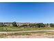 Scenic view of a well-maintained golf course with distant hills against a clear blue sky at 2847 Mount Royal Dr, Castle Rock, CO 80104