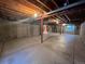 Unfinished basement space featuring concrete flooring, visible beams, and support columns at 3930 S Quatar St, Aurora, CO 80018